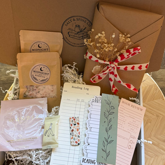 Collection of items including a reading log, bookmarks, and packaged products with 'Salt & Spine Co' branding.